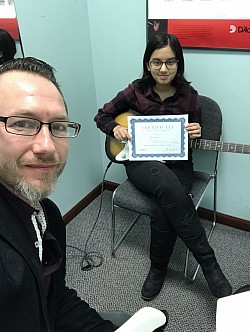 A student getting an Achievement Award for memorizing the Power Chords on the 6th String
